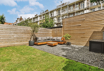 The deck is surrounded by a wooden fence, providing privacy and a modern aesthetic.